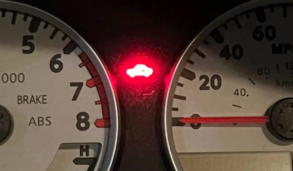 red car with key symbol on dashboard Nissan